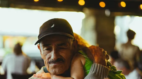 OC Gonzalez: Older man holding a younger child for Family Source Centers 