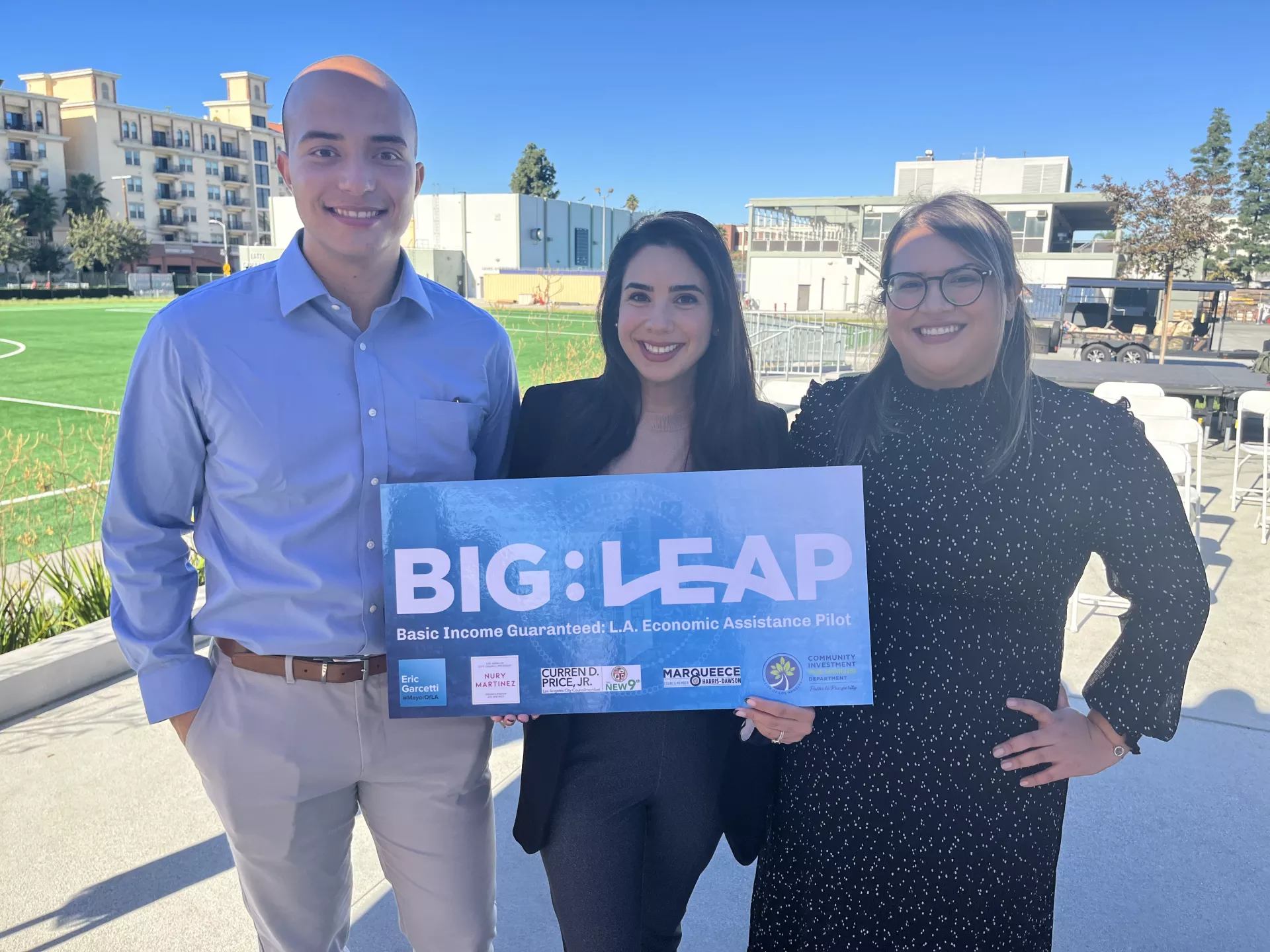 Big Leap Launch with 3 people in the photo and one person is holding the Big Leap sign