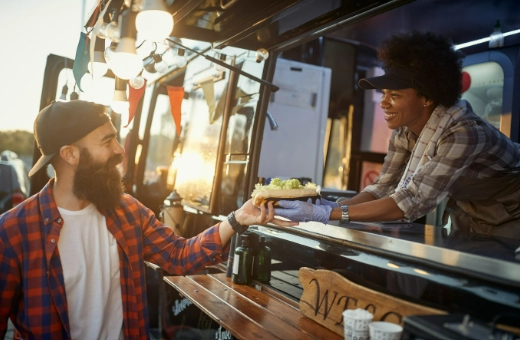 Person inside food truck handing food to a person